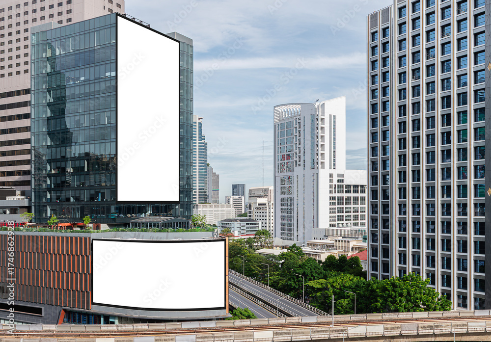 Obraz premium Two white mock up vertical and horizontal large LED display billboard on building with cityscape view background .Clipping path for mockup