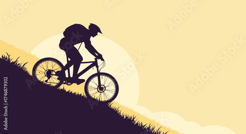 Silhouette of a cyclist riding a mountain bike uphill during sunset.