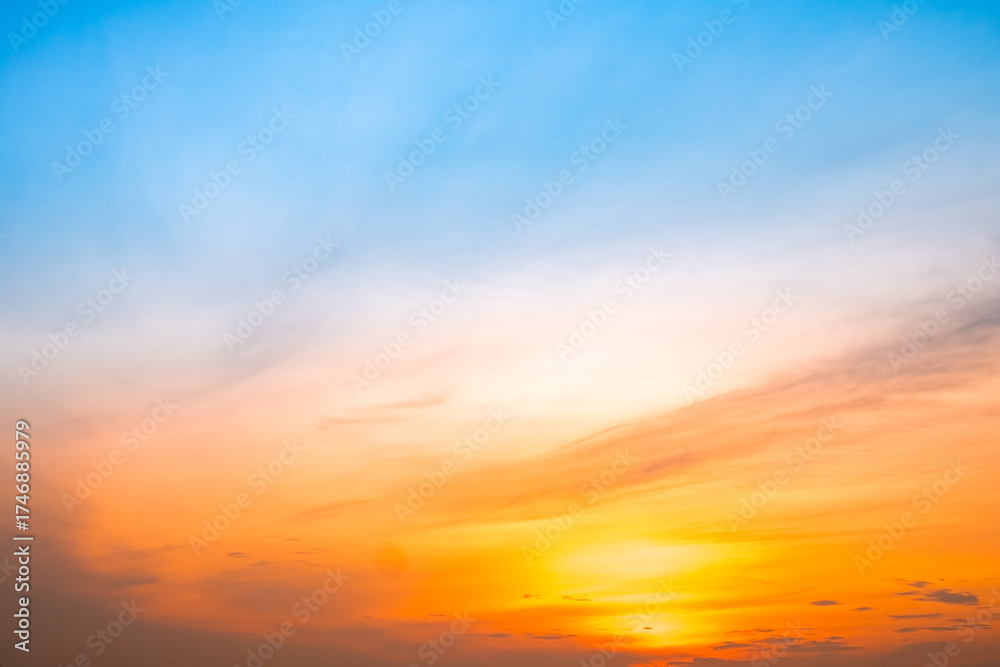 Obraz premium Beautiful , luxury soft gradient orange gold clouds and sunlight on the blue sky perfect for the background, take in evening,Twilight, Large size, high definition landscape photo