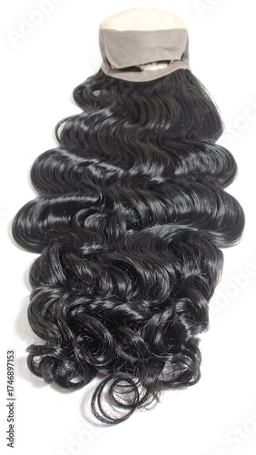A dark wavy hairpiece for styling and beauty, featuring a mesh base and long, cascading curls, isolated against a white backdrop