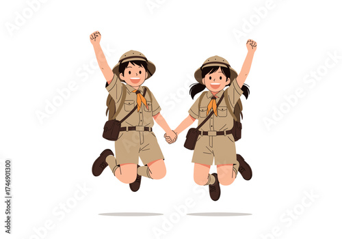 Two happy young scouts are jumping and holding hands wearing explorer outfits and hats.