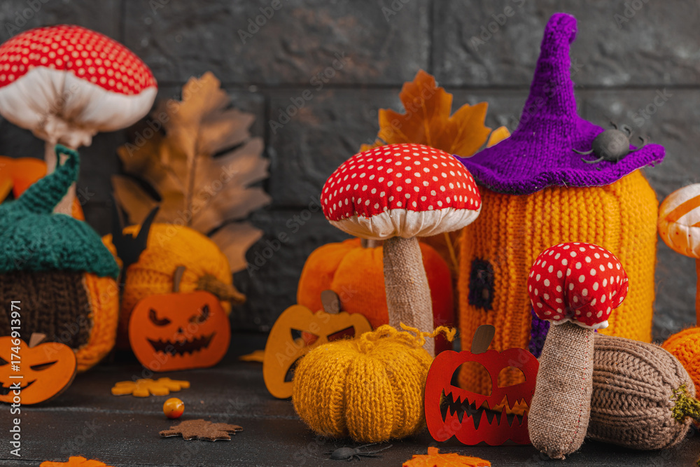 Fototapeta premium Dark Halloween atmospheric composition. Handmade knitted, crocheted, and sewn autumn decor