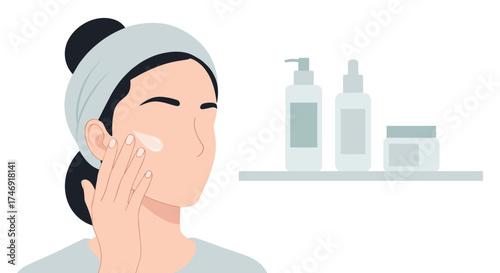 A woman with a headband applying cosmetic cream to her face.