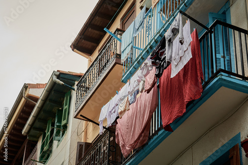 Laundry hanging from balconies in a picturesque street of Getaria’s historic center, a coastal town in the Basque Country. The scene captures everyday life and the charm of Mediterranean architecture.