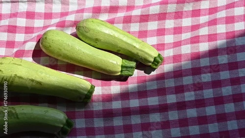 Fresh Green Zucchinis on Kitchen Table in Kitchen Towel