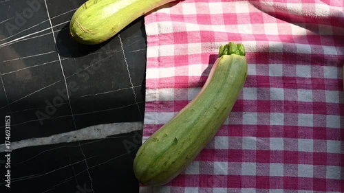 Fresh Green Zucchinis on Kitchen Table in Kitchen Towel