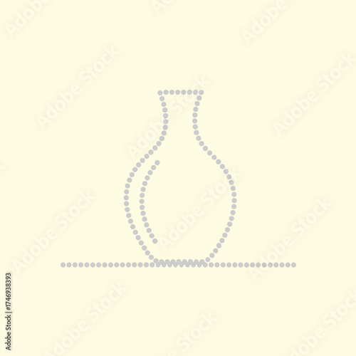 Elegant ceramic vase with a narrow neck and rounded body, placed on a flat against a plain