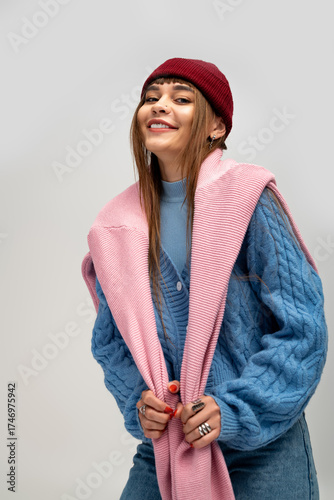 Wallpaper Mural Stylish young woman embracing warmth in cozy autumn attire against a soft backdrop Torontodigital.ca