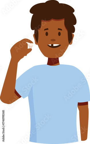 Smiling boy showing missing tooth and holding fallen tooth in his hand