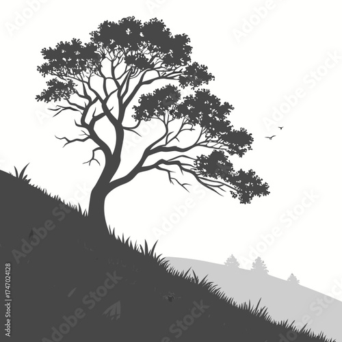 Silhouette of a lone tree on a grassy hill with birds flying