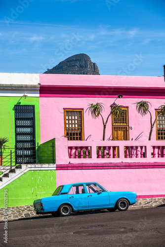 An oldtimer parks in front of the colorful houses in the historic Bo-Kaap district in Cape Town, South Africa