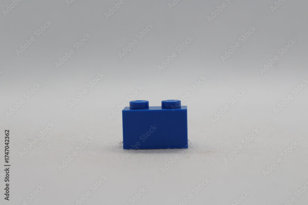 Naklejka premium Blue Lego brick piece isolated on a white background 
