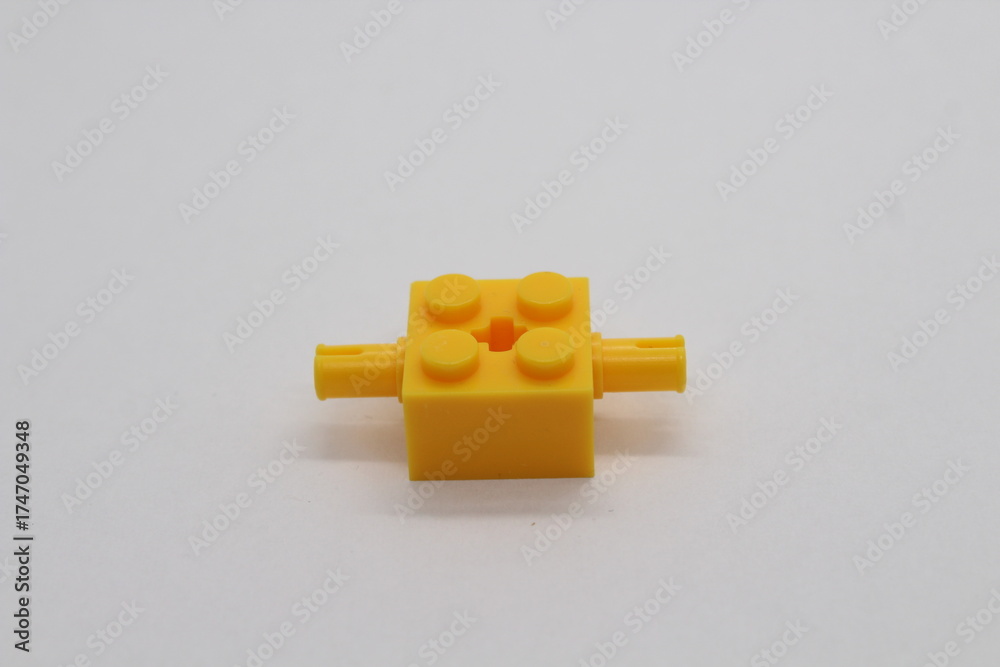 Obraz premium Yellow Lego brick piece isolated on a white background 
