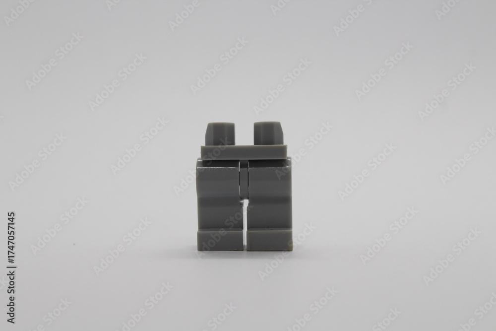 Fototapeta premium Grey Lego figure legs isolated on a white background 