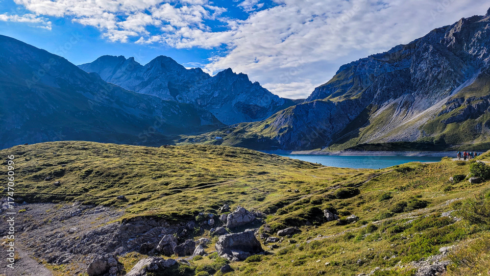 Fototapeta premium An exciting view of the mountain lake Lunersee in the frame of high Alps and green hills in Austria.