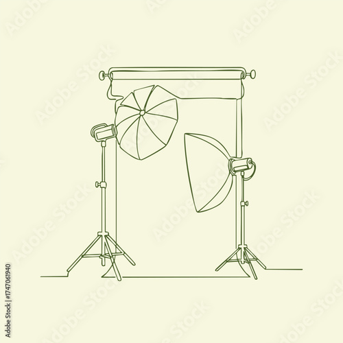 Professional photography studio setup with lighting equipment, umbrellas, and backdrop for portrait or product shoots