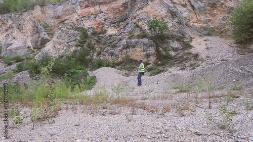 Construction worker inspecting material amount using tablet on construction site
