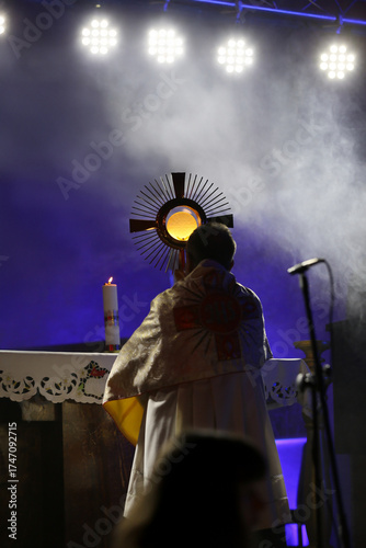 Priest holding the Blessed Sacrament of the Eucharist,