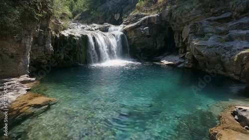 Beautiful waterfall surrounded by cliffs and clear blue water