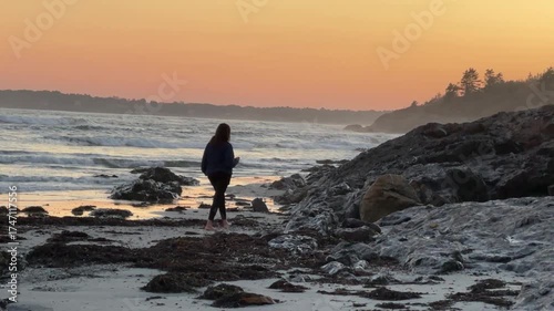 Woman Walking on the Beach Holding a Cocktail Glass