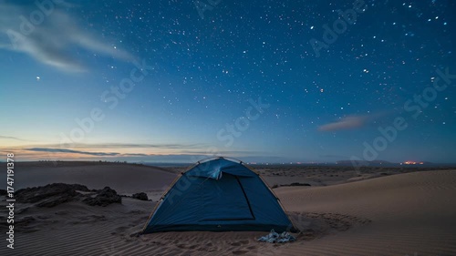 A night to day time-lapse of a tent under a star filled night sky in the Grand Staircase-Escalante National Monument a few miles south of the town of Escalante, Utah
