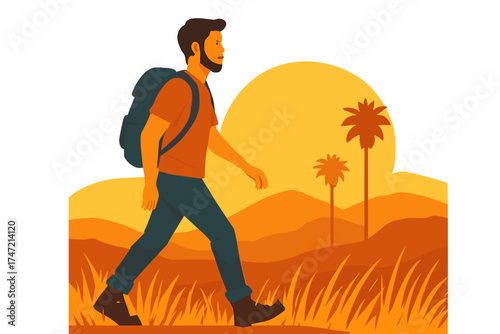 A male millennial hiker walks through grass in Southern California at sunset