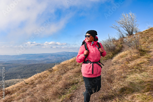 Obraz na plátně Woman hiker on mountain trail in autumn, self-portrait