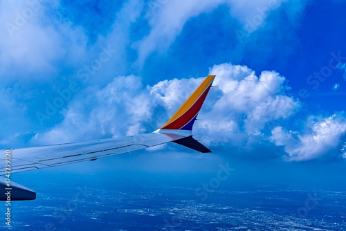 View of a wing from a plane as viewed from the plane window while flying through the sky