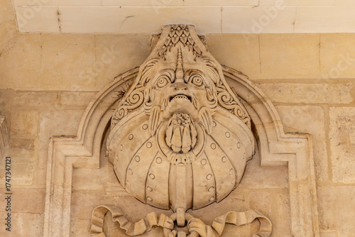 France, Paris. Decorative stone carving of a mythical beast in the Palais Royal complex.