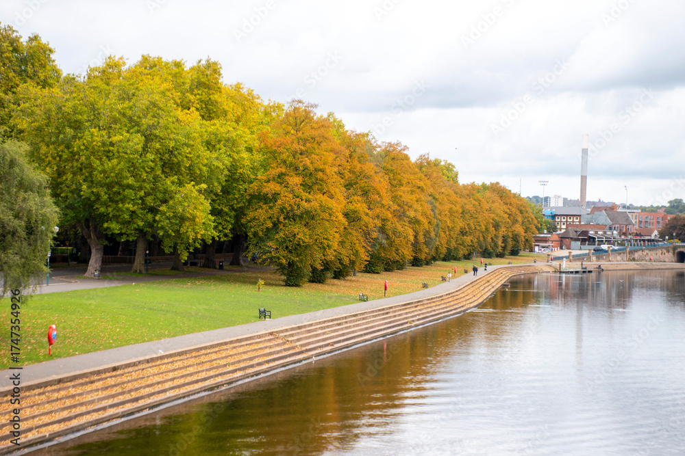 Fototapeta premium A landscape view with the River Trent in Nottingham and Trees in autumn colour along the embankment.
