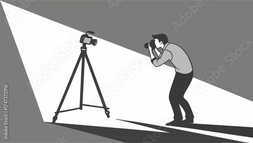 Photographer taking a picture with a camera on a tripod in a studio setting with a spotlight.
