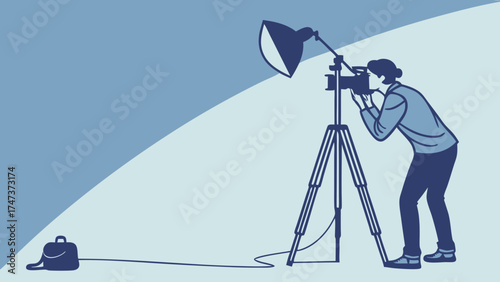 Photographer using a camera on a tripod with lighting equipment.