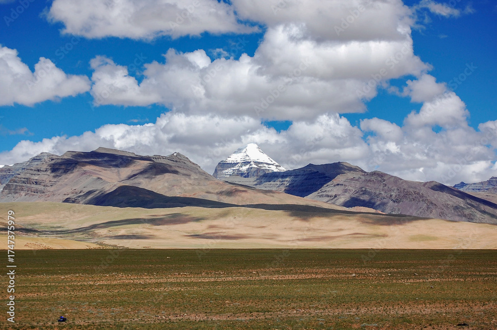 Fototapeta premium Magnificent mountain landscape with snow-capped peak under blue sky