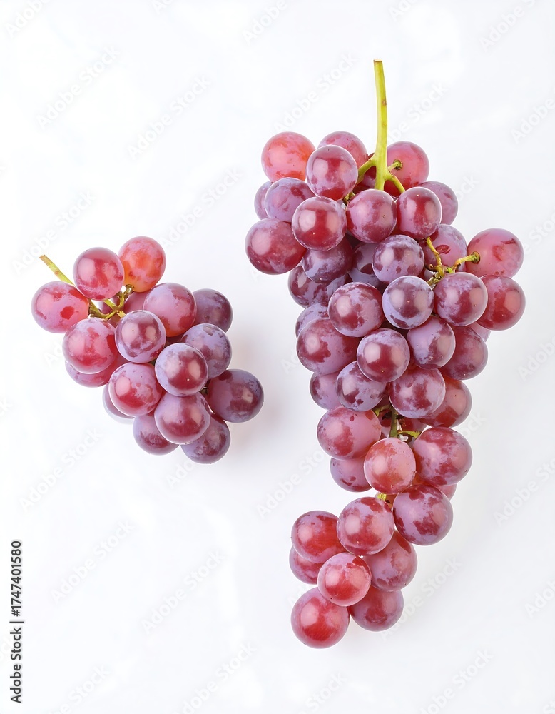 Fototapeta premium Two bunches of red grapes on a white surface