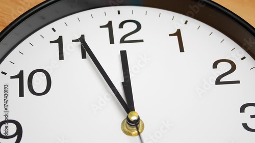 4K Time Lapse close-up wall clock displaying the time at 11:52 symbolizing final moments before midnight, urgency anticipation and the bearing of significant moment or deadline.