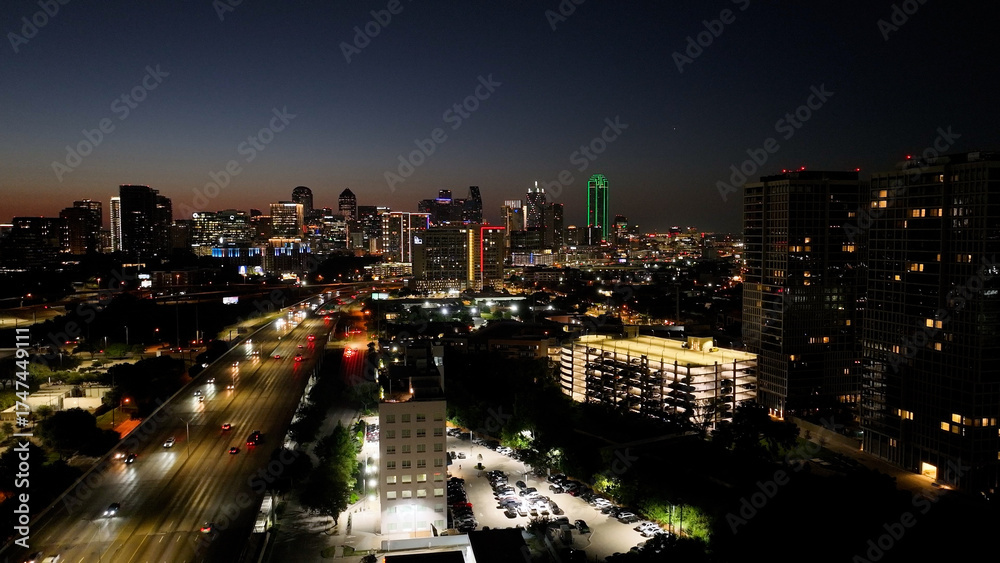 Obraz premium Amazing aerial drone photograph of Dallas city skyline. Photo taken at dawn during the golden hour. View of traffic and buildings lit and the orange glowing of the rising sun.
