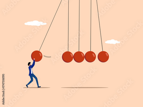 Maintaining momentum, businessman holds a pendulum to strike the pendulum of others