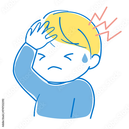 ひどい頭痛のため頭を手で押さえている男の子