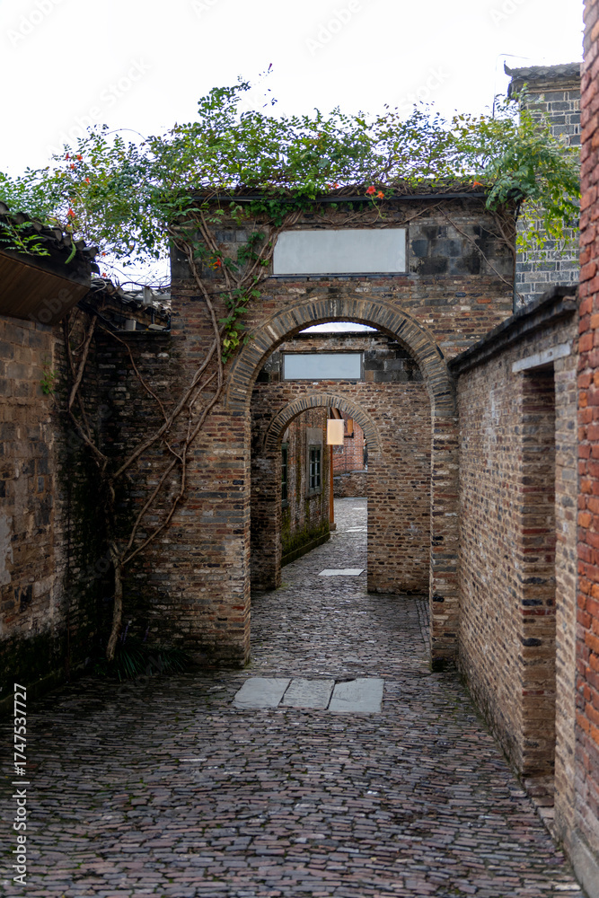 Fototapeta premium Old brick archway in a narrow historical alleyway