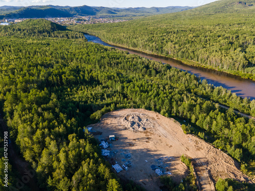 Vast green landscape with river and construction site in Vladivostok, Russia