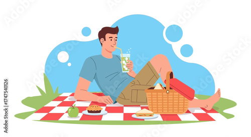 Man enjoying a refreshing drink during a relaxing picnic outdoors in the summer