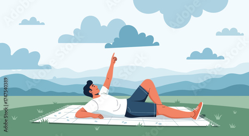 Man enjoying nature lying on a blanket pointing up at the clouds at the park