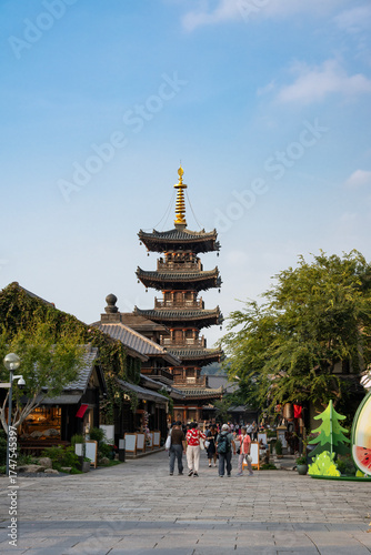 Traditional Chinese pagoda with people walking around it