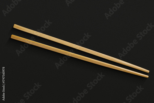 Pair of reusable chopsticks on dark background