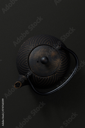 Metal teapot on dark background