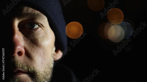 Close up portrait of man closing eye at night with lights in background. Meditation, relax concept