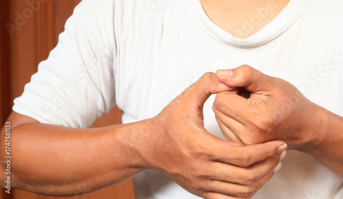Photos Close-up Of Man Hands Cracking His Knuckles At Home. Bad habit