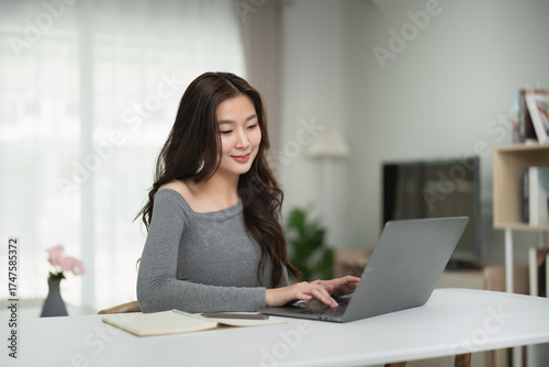 Young Woman Working from Home on Laptop in Comfortable Living Room with Soft Lighting and Cozy Ambiance Free Download Young Woman Working from Home on Laptop in Comfortable Living Room with Soft Lighting and Cozy Ambiance - GFXLoad