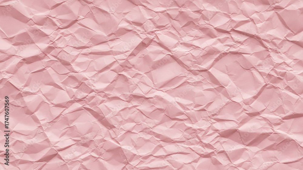 Fototapeta premium Soft pastel pink wrinkled paper with gentle folds and creases creating romantic textured background with subtle shadows and dimensional surface quality.