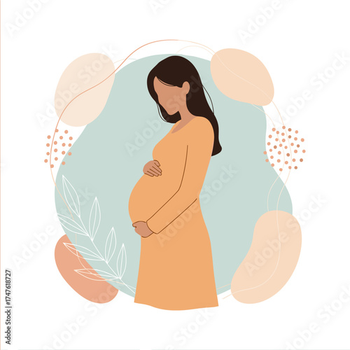 Beautiful pregnant woman holding her belly with a warm gentle smile. .